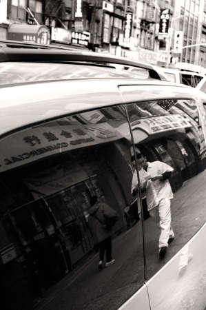 CHINATOWN, NEW YORK CITY, USA, 11 APRIL 2010: Pedestrian walks down street.のeditorial素材