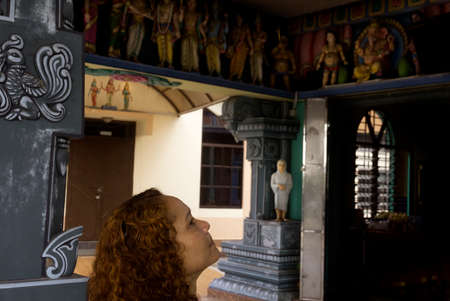 PENANG HILL HINDU TEMPLE, PENANG, MALAYSIA,  5 MAY 2014: A woman looks up at a row of statues at the Sri Aruloli Thirumurugan Hindu Temple atop Penang Hillのeditorial素材