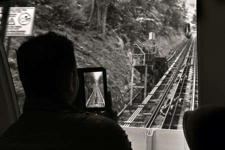 PENANG HILL, GEORGETOWN, PENANG, MALAYSIA,  5 MAY 2014: A Malaysian couple take selfies and photos...