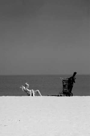 CAPE MAY POINT, NEW JERSEY, USA, 7 JULY 2010: A woman reads on the beach at Cape May Point in New Jersey.のeditorial素材