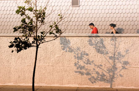 CAPE MAY, NEW JERSEY, USA, 7 JULY 2010: Couple leaving the beach walks by a beach house.のeditorial素材