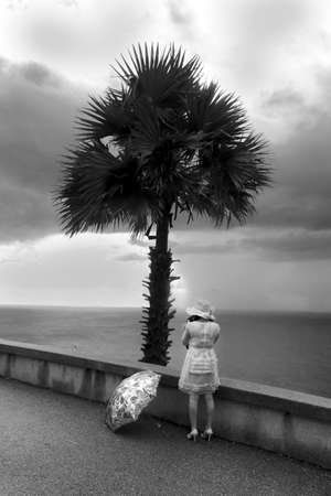 CAPE PROMTHEP, PHUKET, THAILAND, 30 NOVEMBER 2013: Chinese tourist snaps photo of scenic view.のeditorial素材