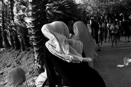 CAPE PROMTHEP, THE TIP OF PHUKET ISLAND, THAILAND, 17 AUGUST 2014: Group of Muslim tourists rest along a path whilst visitng Promthep Cape, one of the most scenic visitas the island of Phuket has to offer.のeditorial素材