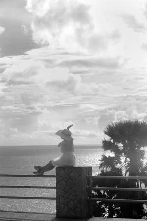 CAPE PROMTHEP, THE TIP OF PHUKET ISLAND, THAILAND, 17 AUGUST 2014: A tourist from China gets her  photo taken whilst visiting Cape Promthep, one of the most scenic vistas the resort island of Phuket has to offer.のeditorial素材