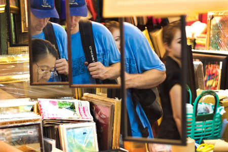 CHATUCHAK MARKET, BANGKOK, THAILAND: 18 MARCH 2012: Tourists shop at Chatuchak Weekend Market in Bangkok.のeditorial素材