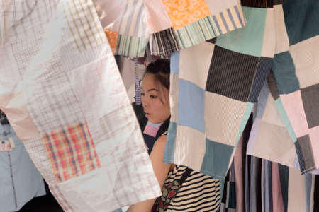 CHATUCHAK MARKET, BANGKOK, THAILAND, 18 MARCH 2012: A vendor at the Chatuchak Weekend Market sets up her stall for business.のeditorial素材