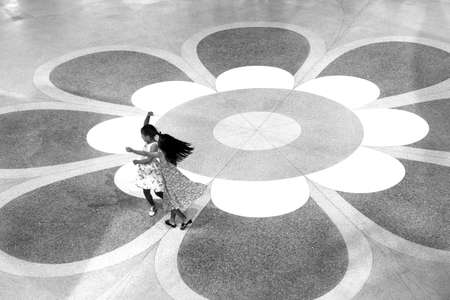 JUNG CEYLON MEGAMALL, PHUKET, THAILAND, 29 JUNE 2012: Two girls dance in an atrium of a shopping mall.のeditorial素材