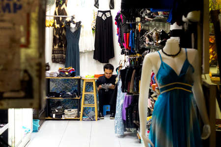 BANGLA RD., PATONG, PHUKET, THAILAND, 22 MAY 2012: A shop owner goes online while working in his store.のeditorial素材