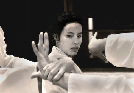 PHUKET TOWN, PHUKET, THAILAND, 3 MARCH 2014: A young Thai college student performs a basic arm lock immobilization with other students during theirr Aikido promotion test.のeditorial素材