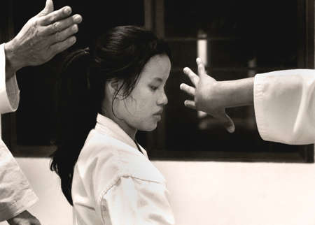 PHUKET TOWN, PHUKET, THAILAND, 3 MARCH 2014: A young Thai college student performs a basic arm lock immobilization with other students during theirr Aikido promotion test.のeditorial素材
