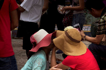 GRAND PALACE, BANGKOK, THAILAND, 26 SEPTEMBER 2014: Two Chinese tourists share an intimate moment while visiting the Grand Palace in Bangkok.のeditorial素材