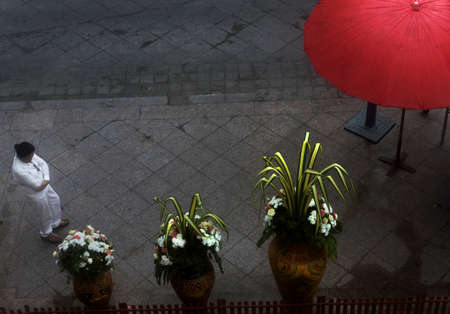 GOLDEN BUDDHA TEMPLE, BANGKOK, THAILAND, 28 SEPTEMBER 2014: A Thai woman in ceremonial white visits the  Golden Buddha during the annual Vegetarian Festivalのeditorial素材