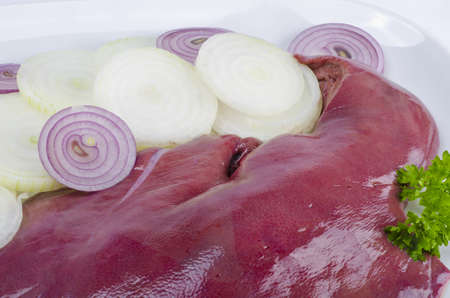 Fresh pork liver with onion and parsleyの写真素材