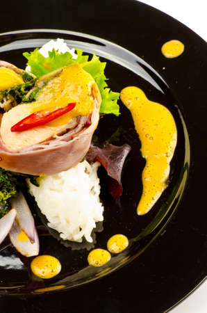 Salmon in ham covers and spinachの写真素材