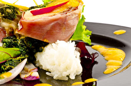 Salmon in ham covers and spinachの写真素材