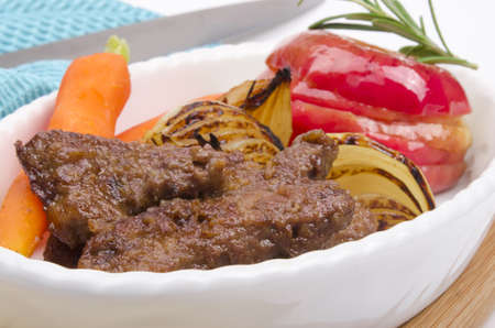roasted liver with vegetables and appleの写真素材