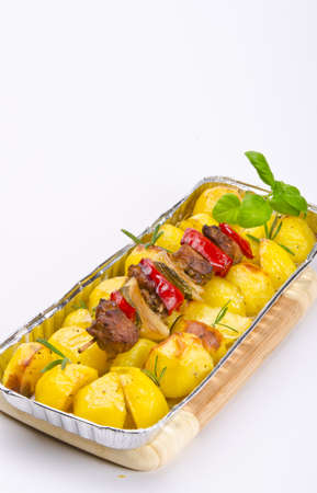 Meat spit with fried potatoesの写真素材