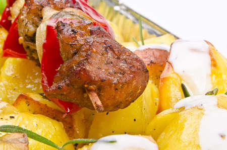 Meat spit with fried potatoesの写真素材