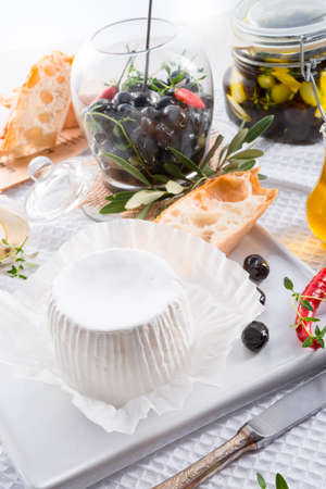 soft cheese with spicy olivesの写真素材