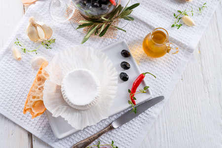 soft cheese with spicy olivesの写真素材