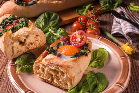 farmer baguette filled with egg, bacon and spinachの写真素材