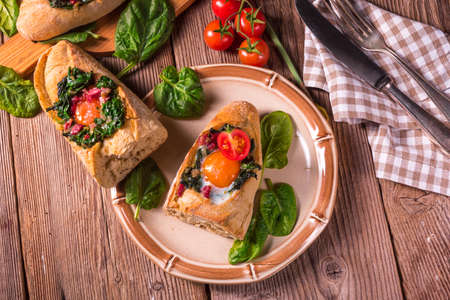farmer baguette filled with egg, bacon and spinachの写真素材