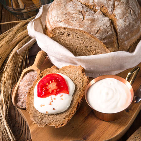 homemade bread with cream and tomatoの写真素材