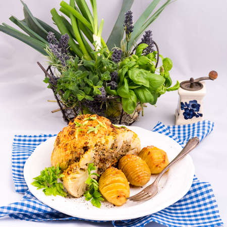 Stuffed cauliflower with mince and Hasselback potatoesの写真素材