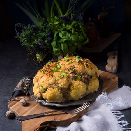 Stuffed cauliflower with mince and Hasselback potatoesの写真素材
