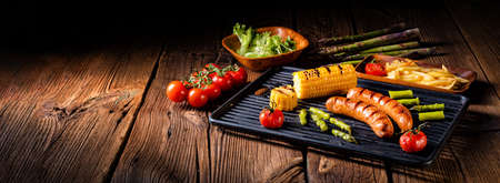 grilled krakauer with french fries and green saladの写真素材