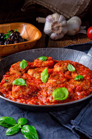 Rustic mini meatballs  Baked  in tomato sauce with basilの写真素材