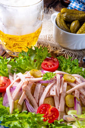 delicious bavarian sausage salad with onion and cucumbersの写真素材