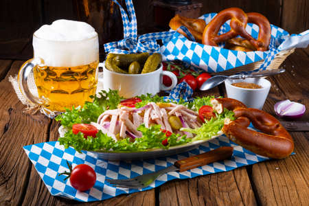 delicious bavarian sausage salad with onion and cucumbersの写真素材