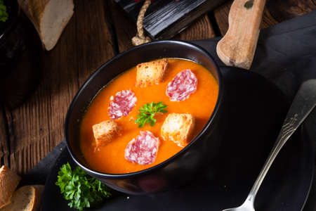 Hungarian paprika cream soup with spicy sausageの写真素材