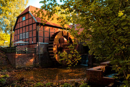 Forest in autumn and a beautiful and picturesque watermillのeditorial素材