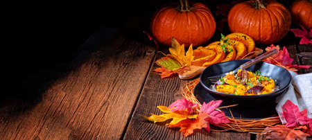 gratinated vegetarian pumpkin with barley groats, plums and thymeの写真素材