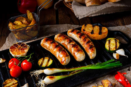 Delicious  grilled sausage with various grilled vegetablesの写真素材