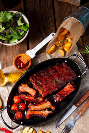 Grilled ribs in spicy marinade with salad and vegetablesの写真素材