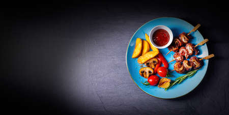 cattle shashlik skewers with grilled vegetables on a caucasian