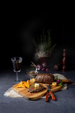 Butter Beef Steak with herbs and potato wedgesの写真素材