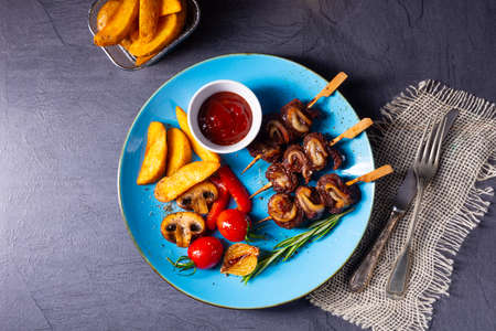 cattle shashlik skewers with grilled vegetables on a caucasianの写真素材