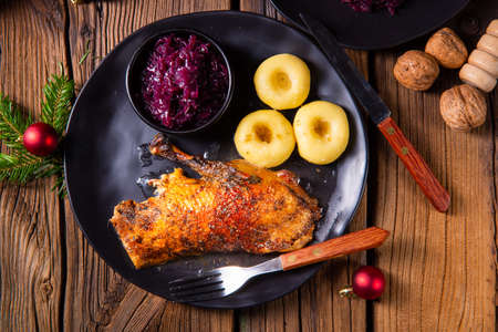 Roast goose with baked apples, red cabbage and dumplingsの写真素材