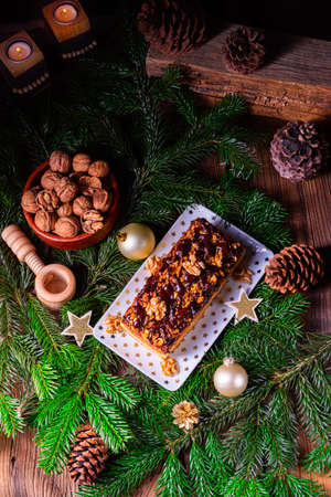 Chocolate gingerbread with filling, jam and nutsの写真素材
