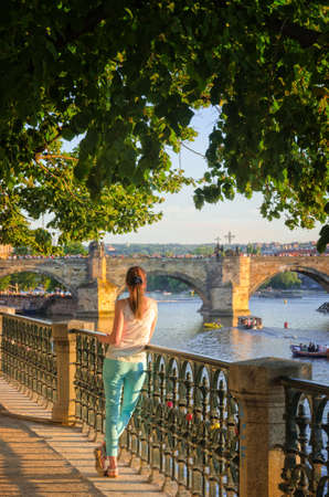 Girls look at the Charles Bridge in Pragueの写真素材