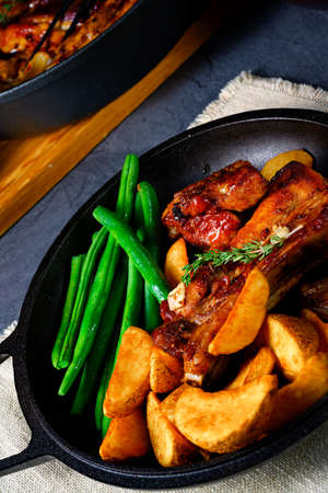 Rib of pork with beans and quarter potatoの写真素材