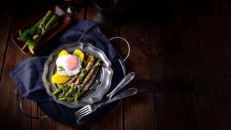 delicious green asparagus wrapped in bacon and eggの写真素材