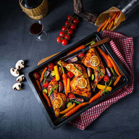 Grilled chicken legs with various vegetables and herbs.の写真素材