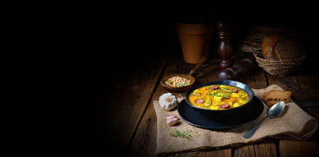 Rustic pea soup with bacon and sausagesの写真素材