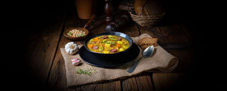 Rustic pea soup with bacon and sausagesの写真素材