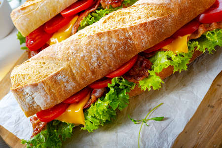 crispy baguette with bacon, tomatoes and cheeseの写真素材